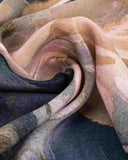 Close-up of a rectangular silk scarf featuring a vibrant blue and pink floral print design.