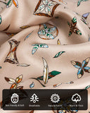 A close-up of a silk scarf with feather alphabet pattern and various symbols highlighting the characteristics and details of its material.