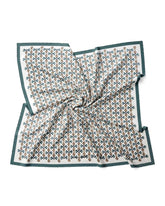 A silk scarf featuring a green and white geometric pattern, elegantly designed in a square shape.