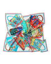 A model in a white shirt adorned with a floral silk head scarf, showcasing elegance and style.