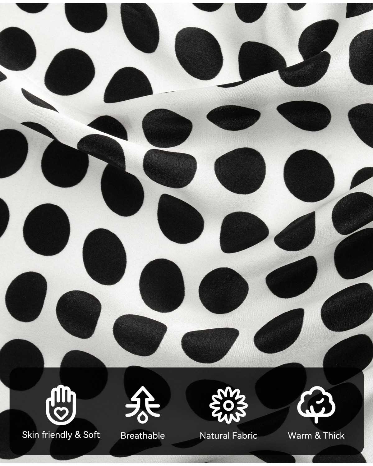 A close-up of a silk scarf with black and white polka dots and various symbols highlighting the characteristics and details of its material.