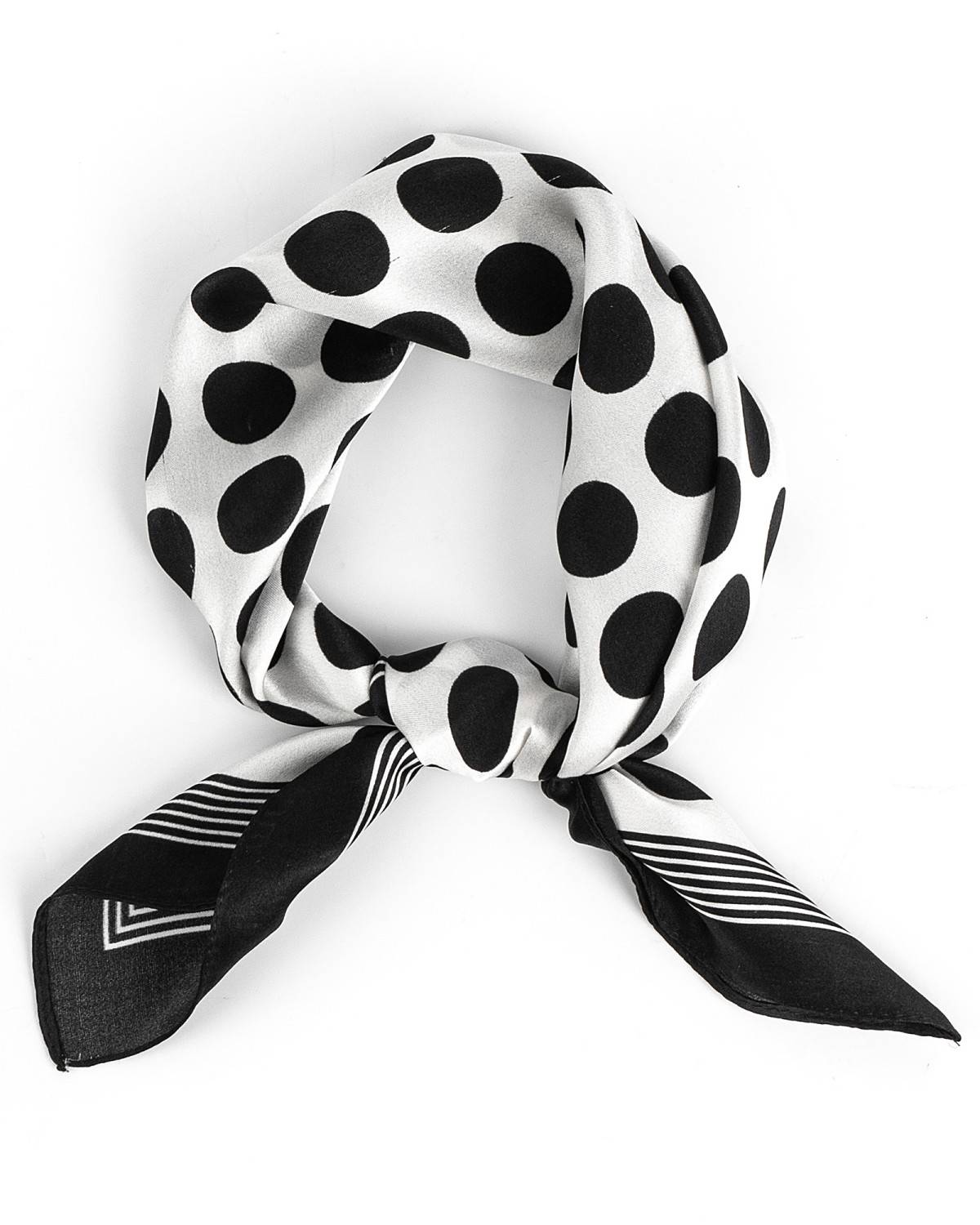 A luxurious silk scarf featuring a black and white polka dot pattern, elegantly knotted for a sophisticated look.
