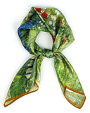 A knotted silk scarf in green featuring a painted tree design, elegantly showcasing nature's beauty.