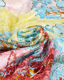 Detailed view of a colorful silk scarf adorned with a tree motif, showcasing its rich hues and textures.