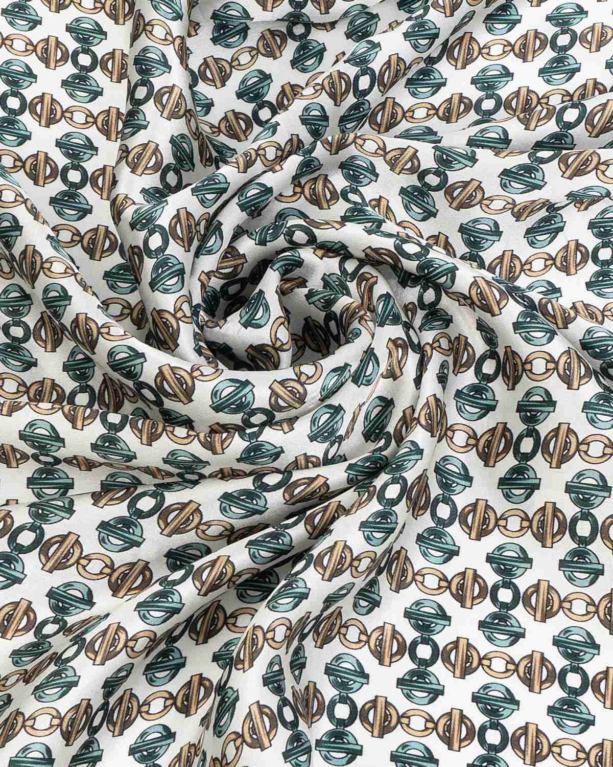 Close-up of a silk scarf featuring a green and brown geometric pattern, showcasing intricate design details.