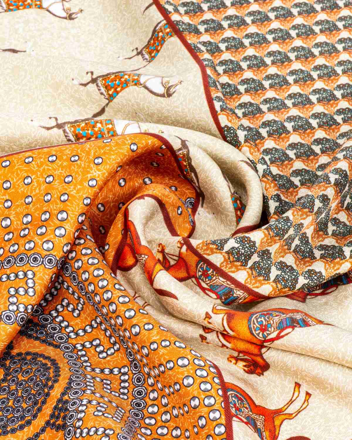 Close-up of a silk scarf featuring a detailed pattern of horses in vibrant colors.