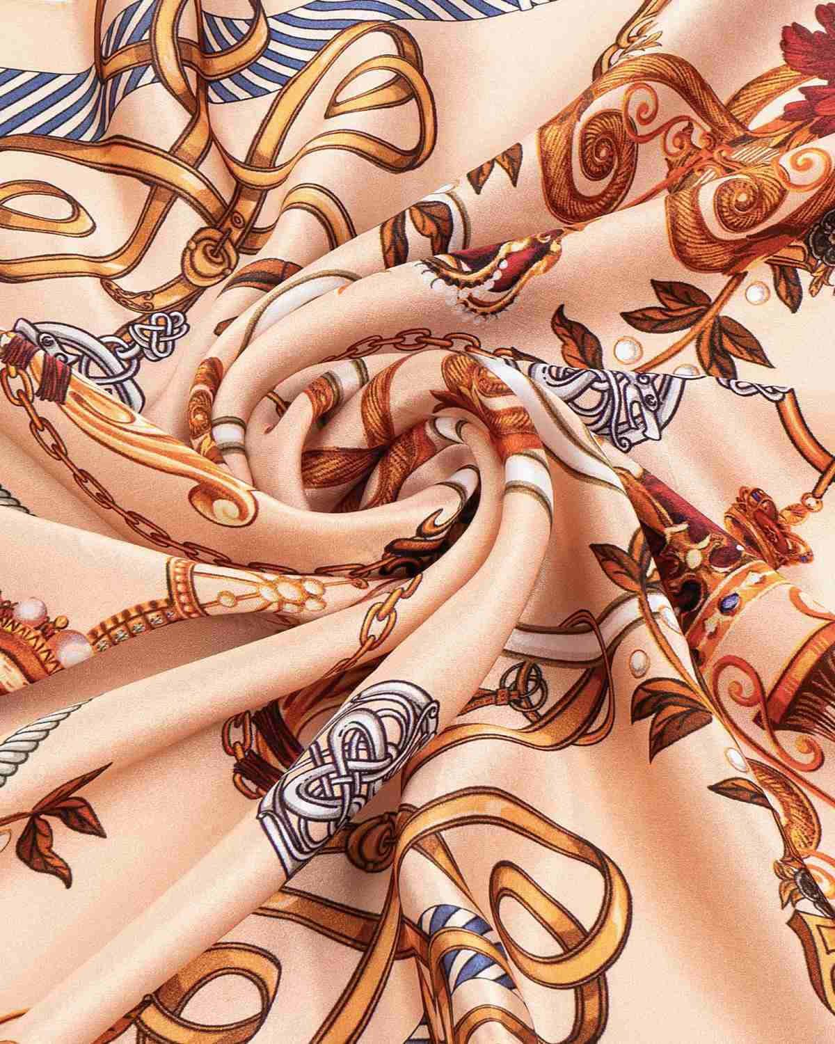 A close-up of a silk scarf featuring a vintage chain pattern, showcasing intricate designs and rich textures.