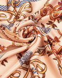 A close-up of a silk scarf featuring a vintage chain pattern, showcasing intricate designs and rich textures.