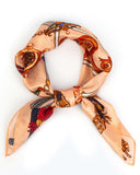 A luxurious silk scarf featuring a vintage chain pattern, elegantly knotted for a sophisticated look.