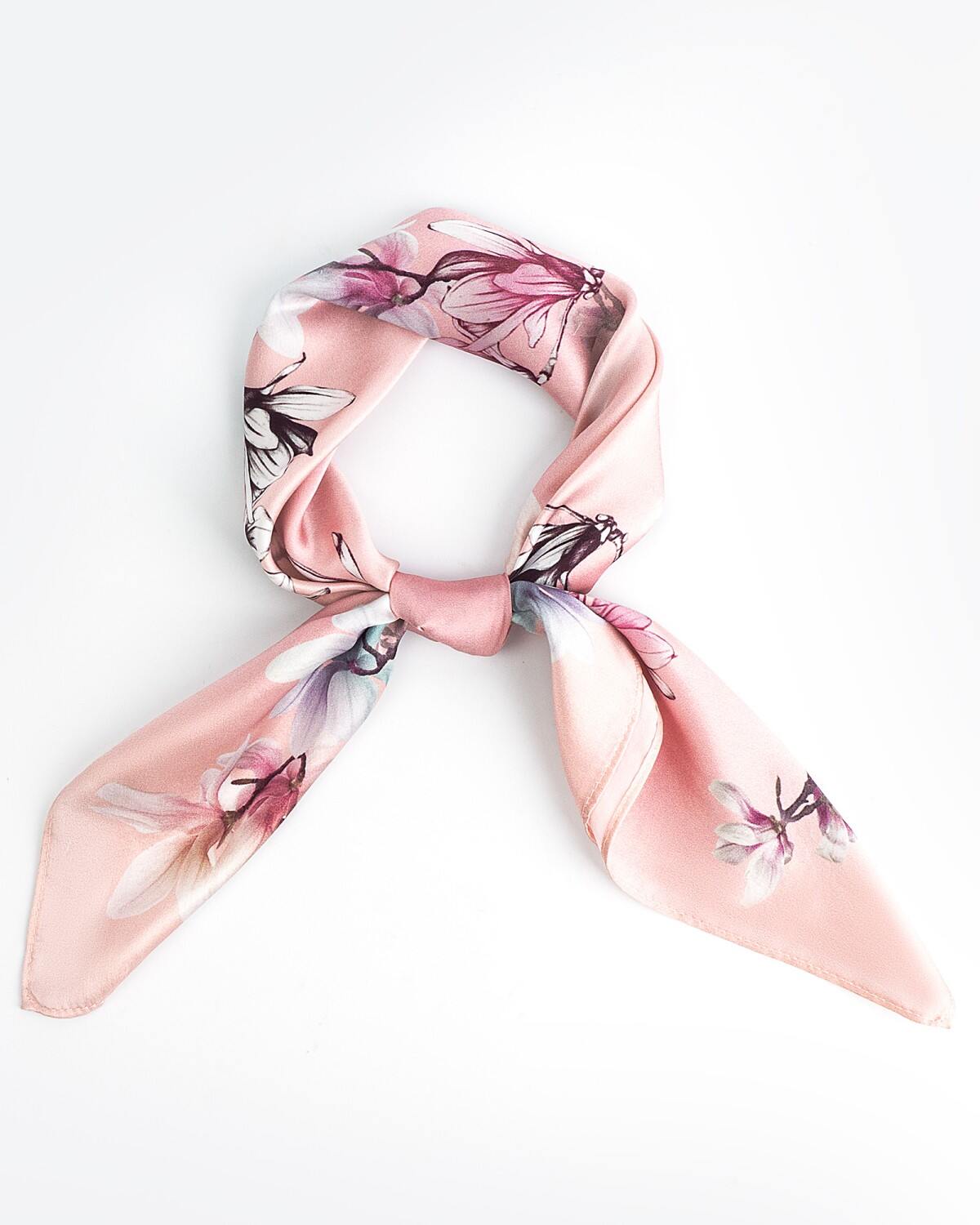 A knotted pink silk scarf featuring a delicate floral design, elegantly displayed against a neutral background.