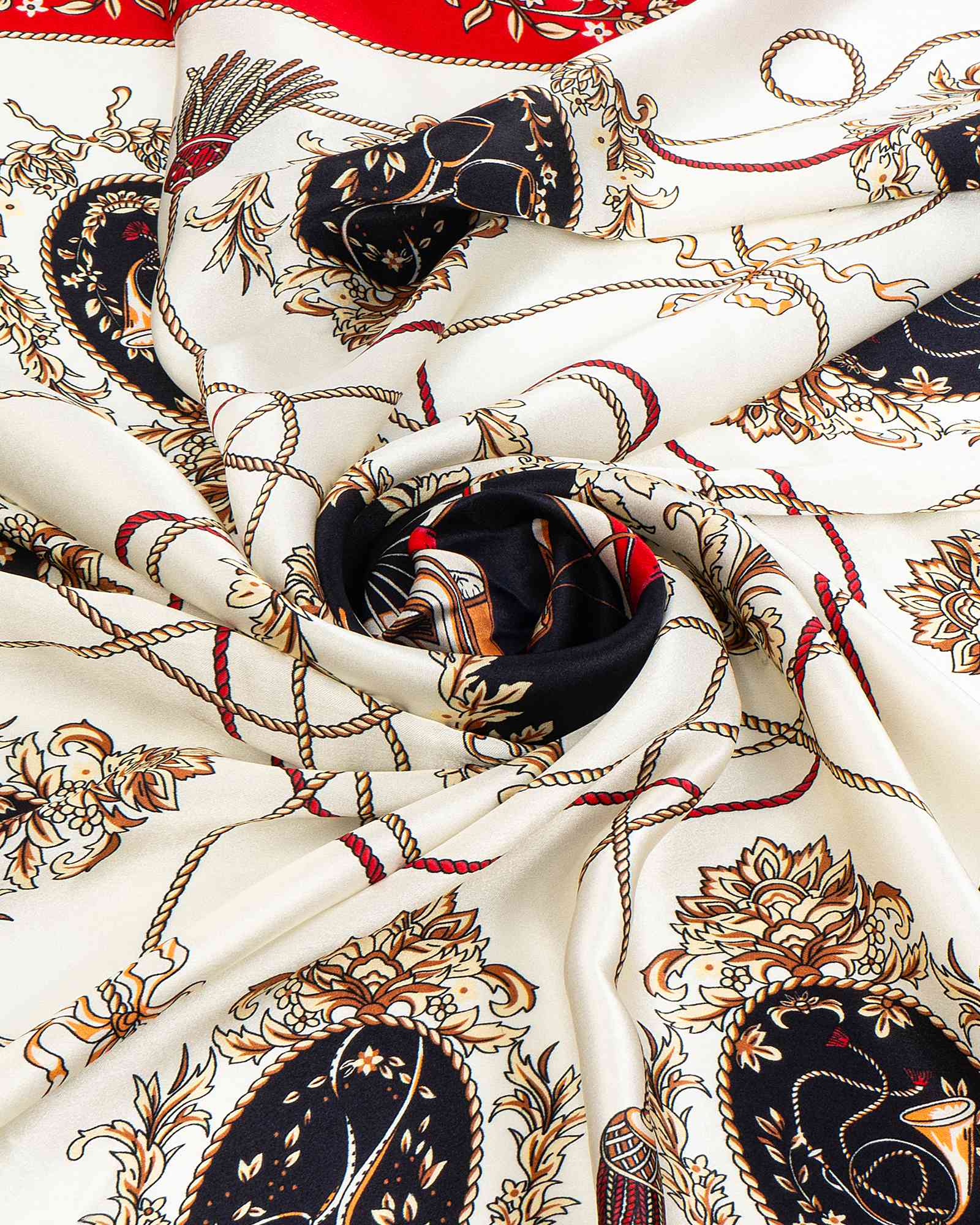 Detailed view of a silk scarf showcasing a white and black color scheme adorned with a red and black motif.